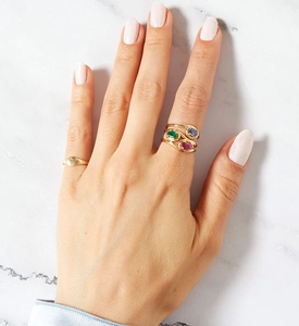 Detail of stacked S925 silver rings with colorful zircon gemstones on model hand