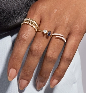 Detail of stacked S925 sterling silver rings with marquise zircons and heart stones