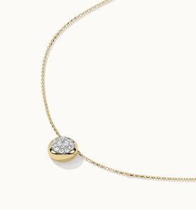 Macro shot of 18K gold plated necklace with a circular disc pendant pavé set with zircons