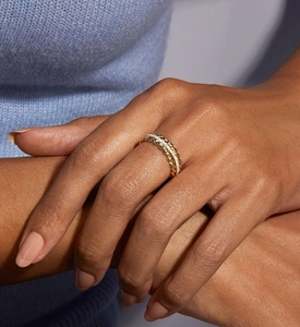 Detail of twisted silver and gold ring with zircon wheat pattern on model hand