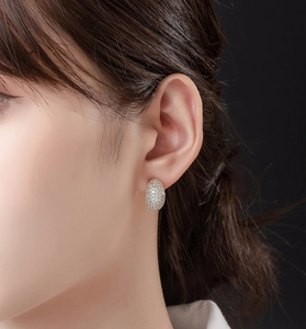 Close-up of elegant S925 sterling silver oval stud earrings with pavé cubic zirconia