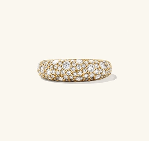 Macro view of gold pavé dome ring with sparkling white round-cut zircon stones