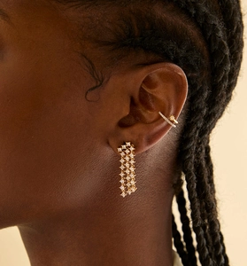 Model wearing gold S925 silver fringe earrings and star ear cuff with zircon stones