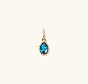 Detailed view of water drop blue crystal pendant with gold plating and faceted stone