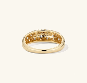 Detail shot of a gold ring featuring star-set sparkling zircon pavé on a wide band