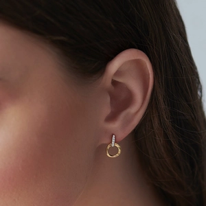 Elegant S925 sterling silver hoop earrings with diamond accents worn by a model