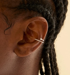 Close-up of S925 sterling silver ear cuff with zircon star design on model ear