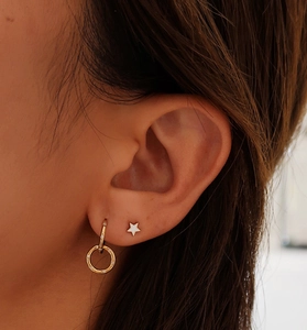 Macro shot of 925 sterling silver interlocking gold earrings with sparkling zircon