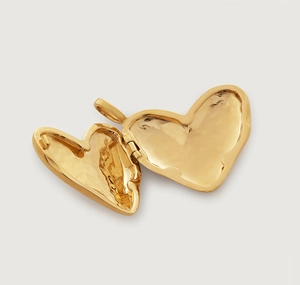 Detailed close-up of a polished gold heart locket pendant with an open hinge structure