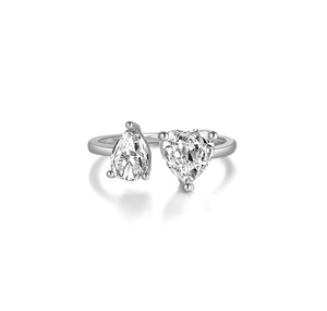 Macro shot of silver ring featuring pear and heart-cut cubic zirconia side by side