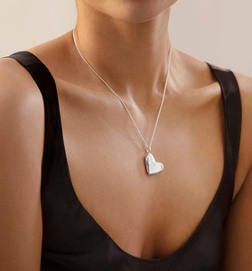 Close-up of S925 sterling silver heart-shaped locket pendant on a delicate chain