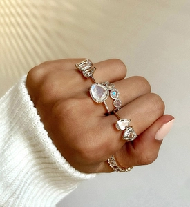 Close-up of stacked gold adjustable S925 rings with pear and heart shaped zircon stones
