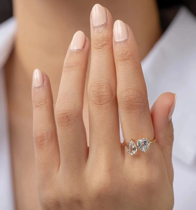 Close-up of elegant gold plated S925 silver ring featuring two pear-cut zircon stones