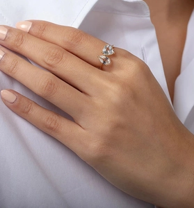 Detail of adjustable gold ring with pear and heart-cut cubic zirconia on model hand