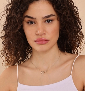 Detail of gold S925 sterling silver double ring necklace with pavé diamond pendant