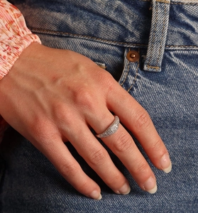 Detail of S925 sterling silver ring with pavé cubic zirconia worn on a finger