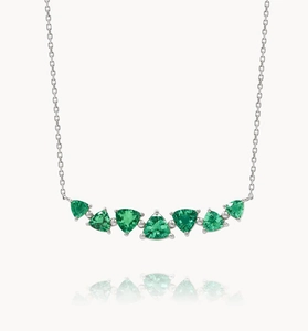 Detail showing seven triangle-cut green emerald stones arranged in a graceful curved necklace