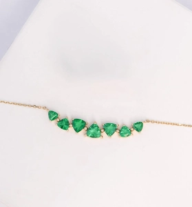 Detailed close-up of 925 sterling silver necklace with triangular green zircon stones