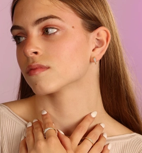Close-up of elegant S925 silver 18K gold-plated pavé zircon earrings and rings set