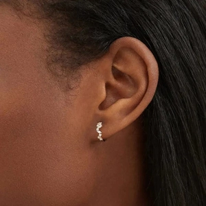 Elegant S925 silver irregular wave earrings with marquise stones on female model