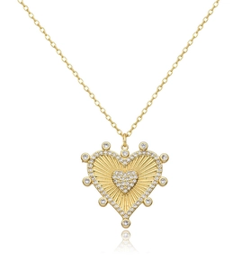 Close-up of golden heart pendant with sunburst texture and sparkling zircon stones on thin chain