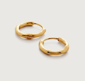 Macro shot of 18k gold plated hoop earrings with organic irregular lava texture