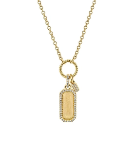 Macro shot of gold rectangle pendant with pavé set cubic zirconia and rope ring detail
