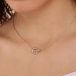 Elegantly layered double ring pendant necklace in rose gold with shimmering zircons