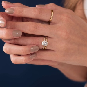 Elegant S925 sterling silver ring set with emerald cut cubic zirconia on a gold band