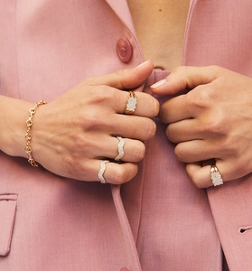 Macro detail of S925 sterling silver rings with pavé cubic zirconia and chunky chain bracelet