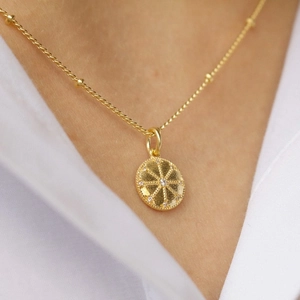 Elegant gold plated S925 silver necklace with sparkling zircon sunburst pendant on model