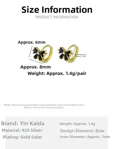 Detail view of gold-plated S925 silver hoop earrings with black zircon bow charms