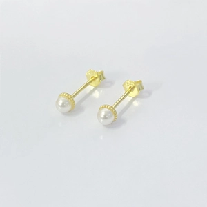 Macro shot of S925 sterling silver hallmark and white pearl stud earrings on white backdrop