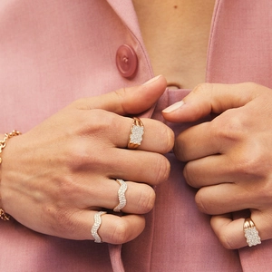 Elegant gold plated S925 silver wave rings with pavé zircon stones on pink blazer background