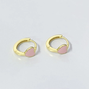 Detailed view of gold hoop earrings featuring pink enamel heart-shaped charms