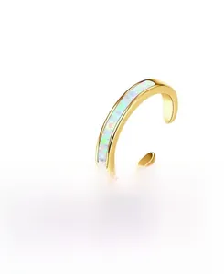 Detail of gold-plated open toe ring featuring iridescent rectangle opal inlay