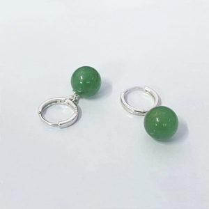 Macro shot of S925 sterling silver stamp on green aventurine beaded drop earrings