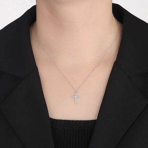 Elegant S925 sterling silver cross necklace with pavé zircons worn on a black blazer