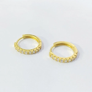 Detailed close-up of gold-plated hoop earrings with pave-set cubic zirconia stones