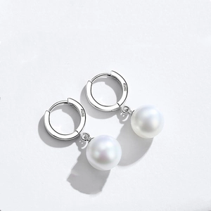 Close-up of S925 sterling silver hallmark and white round pearl on dangle earrings