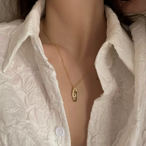Elegant gold S925 silver interlocking double ring necklace on model with white shirt