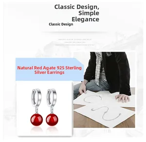 Close-up of natural red agate pendant earrings made of 925 sterling silver with classic design