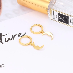 Close-up of S925 sterling silver gold moon huggie hoop earrings with hallmark detail