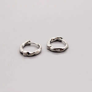Detail of twisted rope texture on silver huggie hoop earrings with secure click closure