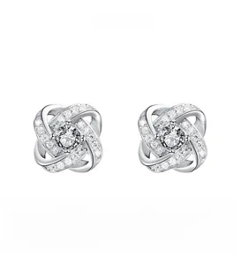Detail view of twisted silver earrings with a round center zircon and crystal paving
