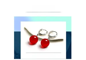 Macro shot of S925 sterling silver hoop earrings with polished red agate beads