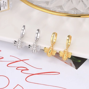 Gold and silver bee pendant hoop earrings featuring detailed engraved wings and body