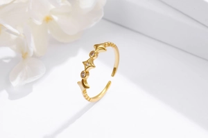 Detailed view of adjustable gold star ring featuring three sparkling round zircons