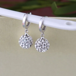 Macro shot of S925 sterling silver hoop earrings with shimmering crystal pavé disco balls