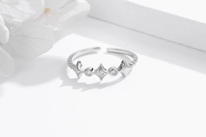 Close-up of S925 sterling silver open ring featuring star motifs and clear zircon stones
